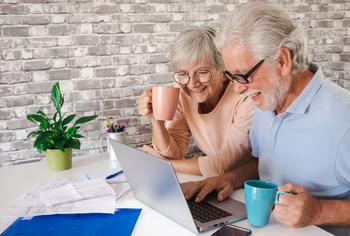 3 High-Yielding Dividend Stocks That Can Help Bankroll Your Retirement Years: https://g.foolcdn.com/editorial/images/773642/a-couple-sitting-and-using-a-laptop.jpg