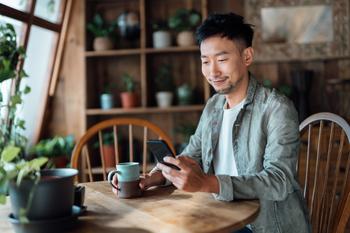 Forget the Dow Jones: Buy This Magnificent ETF Instead: https://g.foolcdn.com/editorial/images/790613/getty-smiling-at-phone-at-table.jpg