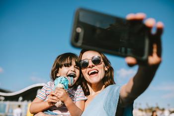 2 Reasons to Buy AT&T Stock, and 2 Reasons to Avoid It: https://g.foolcdn.com/editorial/images/749640/person-taking-selfie-with-child.jpg