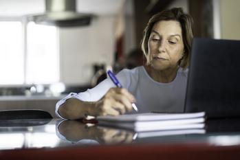 2 Pros and 2 Cons of Claiming Social Security at Age 67: https://g.foolcdn.com/editorial/images/746130/older-woman-taking-notes-laptop-gettyimages-1143057831.jpg