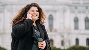 The Most Important Retirement Table You'll Ever See: https://g.foolcdn.com/editorial/images/771499/getty-happy-smiling-person-on-phone-in-front-of-building.jpg