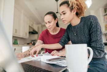 3 Ways to Lower Interest On Your Student Loans: https://g.foolcdn.com/editorial/images/735611/reviewing-finances.jpg