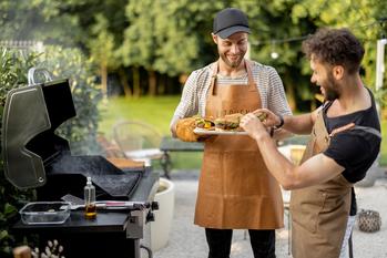 Why Weber Stock Popped Today: https://g.foolcdn.com/editorial/images/696430/two-people-smile-in-an-outdoor-setting-while-eating-recently-grilled-hamburgers.jpg