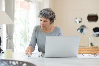 Retiring Soon? 2 Overlooked Moves You Want to Make Now: https://g.foolcdn.com/editorial/images/769967/older-adult-sitting-at-table-in-front-of-computer-looking-at-receipts-and-paying-bills.jpg