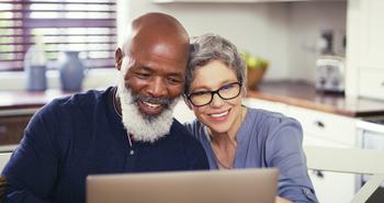 Tired of Stressing About Retirement? 3 Moves That Will Boost Your Confidence: https://g.foolcdn.com/editorial/images/733937/older-couple-at-laptop-smiling-gettyimages-1217601970.jpg