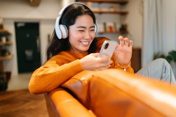 Spotify Stock Has 26% Upside, According to 1 Wall Street Analyst: https://g.foolcdn.com/editorial/images/771992/smiling-at-smartphone-in-orange-couch.jpg