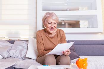 Is It Easier to Make a Social Security Filing Decision When You're Single?: https://g.foolcdn.com/editorial/images/717990/senior-woman-smiling-reading-document-gettyimages-1205215075.jpg