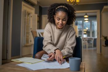 Can Teens Invest Their Summer Job Earnings in a Roth IRA?: https://g.foolcdn.com/editorial/images/781740/young-person-making-calculations-at-desk.jpg