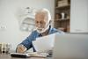 Should You Retire at Age 70? Here Are 2 Pros and 1 Pretty Big Con: https://g.foolcdn.com/editorial/images/773880/older-man-at-desk-serious-gettyimages-1367292739.jpg