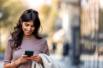 If You Had Invested $10,000 in Apple When the iPhone Came Out, This Is How Much You Would Have Today: https://g.foolcdn.com/editorial/images/752369/woman-looking-at-phone.jpg