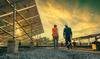 These Beaten-Down Energy Stocks Have a Big Potential Catalyst: https://g.foolcdn.com/editorial/images/722422/two-people-walking-near-solar-energy-panels.jpg