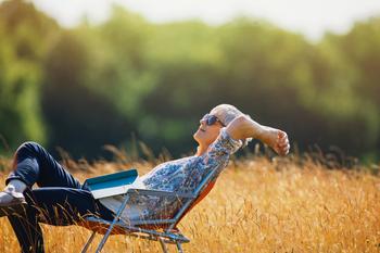 This Social Security Strategy Could Net You an Extra $182,000 in Retirement: https://g.foolcdn.com/editorial/images/767075/relaxed-person-with-book-on-lap-sitting-in-field.jpg