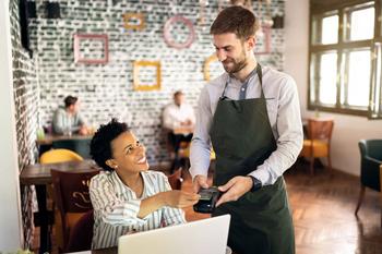 Can a Change in CEO Help Turn Starbucks' Business Around?: https://g.foolcdn.com/editorial/images/787591/worker-in-a-coffee-shop-taking-a-customers-payment.jpg