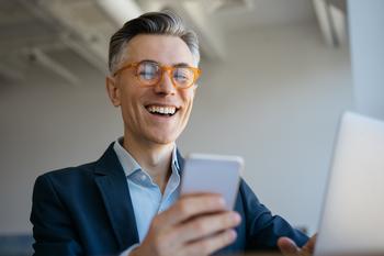 The New Bitcoin ETFs Are a No-Brainer Way to Build Wealth, but Only If You Plan to Buy and Hold for the Long Term: https://g.foolcdn.com/editorial/images/762155/a-smiling-man-at-a-laptop-holding-a-cell-phone.jpg