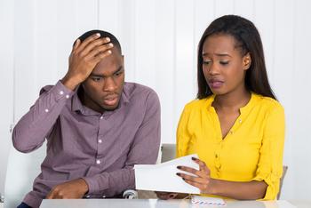 3 Ways to Help Your 401(k) Survive a Recession: https://g.foolcdn.com/editorial/images/693414/young-couple-worried-looking-at-bill-expense-finance-poc.jpg