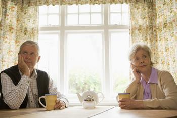 What Happens to Your Social Security If You Get Divorced?: https://g.foolcdn.com/editorial/images/766745/senior-man-and-woman-sitting-at-table-resting-their-faces-on-their-hands-looking-bored-couple-retirement.jpg