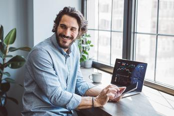 2 Growth Stocks to Buy Before the Next Bull Market: https://g.foolcdn.com/editorial/images/740585/smiling-investor-uses-a-laptop-and-holds-a-tablet.jpg