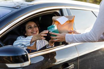 Is Starbucks Stock a Buy After Its Massive Drop?: https://g.foolcdn.com/editorial/images/775917/person-getting-coffee-and-a-bag-of-food-at-a-drive-thru.jpg