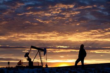 Up 35% in This Bear Market, Is Devon Energy Still a Winner?: https://g.foolcdn.com/editorial/images/716249/a-person-looking-at-an-oil-pump-with-the-sun-setting-in-the-background.jpg