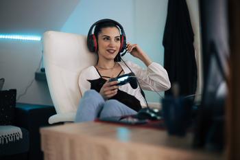 With Activision Deal Cleared, Is Microsoft Stock a Buy?: https://g.foolcdn.com/editorial/images/732591/a-young-person-wearing-a-headset-and-holding-a-gaming-controller-smiling.jpg
