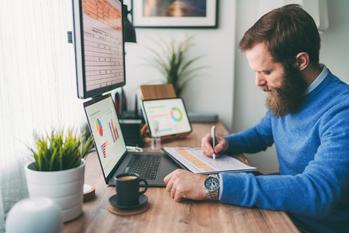 Is Adobe Stock a Buy Now?: https://g.foolcdn.com/editorial/images/742351/bearded-person-at-desk-by-computer-taking-notes.jpg