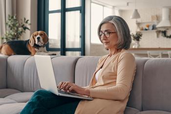 Here's a Good Reason to Delay Your Medicare Enrollment: https://g.foolcdn.com/editorial/images/750775/older-woman-laptop-dog-in-background-gettyimages-1307241175.jpg