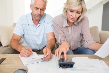 3 Signs You're Ready to Retire in 2023 -- and 1 Good Reason to Wait: https://g.foolcdn.com/editorial/images/718360/mature-couple-looking-at-documents-and-using-calculator-bills-finances.jpg