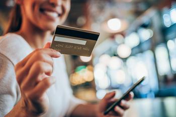 Should You Buy Visa While It's Below $275?: https://g.foolcdn.com/editorial/images/787838/person-smiling-while-holding-a-payment-card-and-smartphone.jpg