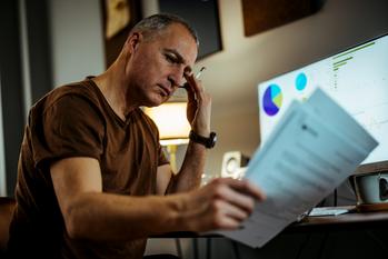 Should Working Longer Be Your Backup Plan if You Don't Manage to Build Retirement Savings?: https://g.foolcdn.com/editorial/images/726467/middle-aged-man-serious-looking-at-documents-gettyimages-1372745764.jpg