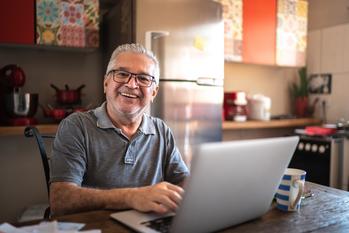 Forget the 4% Rule. Here's What You Should Really Be Looking at During Retirement.: https://g.foolcdn.com/editorial/images/779231/older-man-laptop-smiling-gettyimages-1278322389.jpg