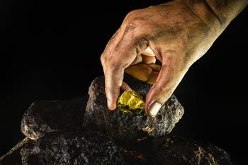 2 Top Bargain Stocks Ready for a Bull Run: https://g.foolcdn.com/editorial/images/763497/miner-picks-up-gold-nugget-from-dirty-ore.jpg