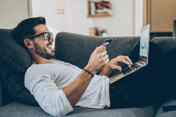 Better E-Commerce Buy: Amazon vs. Etsy: https://g.foolcdn.com/editorial/images/741886/gettyimages-man-shops-online_lies-on-couch.jpg