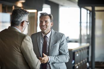 Why It Pays to Work Past Retirement Age -- Even If You Don't Need the Money: https://g.foolcdn.com/editorial/images/747432/two-people-in-business-attire-standing-and-talking_gettyimages-669887594.jpg