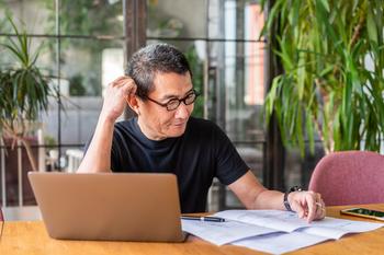 Working and Claiming Social Security? The Government May Take a Cut After You Earn This Much in 2024: https://g.foolcdn.com/editorial/images/756228/older-worker-with-laptop-looking-at-documents-and-thinking.jpg