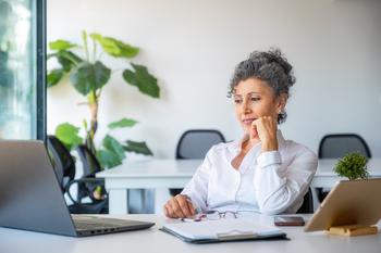3 Reasons to Reconsider Early Retirement: https://g.foolcdn.com/editorial/images/770914/older-woman-in-office-working-office.jpg