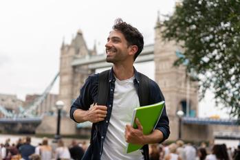 When Is It Worth It to Go Abroad for College?: https://g.foolcdn.com/editorial/images/744588/getty-happy-college-student-in-london-study-abroad-millennial-gen-z.jpg