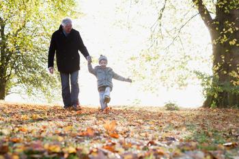 Is a Living Trust Really the Best Way to Pass an Inheritance to Your Family?: https://g.foolcdn.com/editorial/images/770385/grandad-grandkid-kicking-leaves.jpg