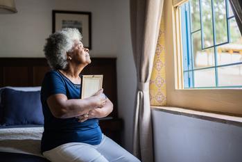 What Happens to Your Social Security Spousal Benefit if Your Spouse Dies?: https://g.foolcdn.com/editorial/images/765918/mourning-loved-one-holding-picture-frame.jpg