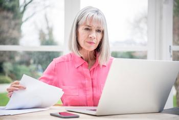 3 Things to Consider Before You Come Out of Retirement: https://g.foolcdn.com/editorial/images/691854/serious-senior-holding-document-and-looking-at-laptop.jpg