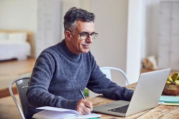 Here's How You Can Tap Your 401(k) Early -- Without a Costly Penalty: https://g.foolcdn.com/editorial/images/779105/middle-aged-man-notes-laptopgettyimages-689980076.jpg