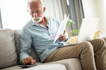 3 Tax Hits Retirees Need to Watch Out For: https://g.foolcdn.com/editorial/images/773570/senior-man-couch-docs-calc-laptop-gettyimages-1343962734.jpg