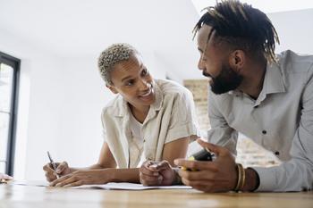 2 Top Payment Stocks to Buy in September: https://g.foolcdn.com/editorial/images/746051/two-people-leaning-forward-on-desk-talking.jpg