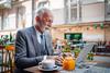 1 in 5 Americans Think They'll Be Stuck Having to Work in Retirement. Here's Why That's Not Such a Bad Thing: https://g.foolcdn.com/editorial/images/751696/older-man-suit-laptop-outdoor-restaurant-gettyimages-1702393349.jpg