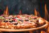 Why Domino's Pizza Stock Is Piping Hot on Thursday: https://g.foolcdn.com/editorial/images/736485/hot-pizza-on-an-open-flame.jpg
