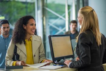 Bank of America: Buy, Sell, or Hold?: https://g.foolcdn.com/editorial/images/757288/customer-holding-document-and-smiling-while-bank-teller-serving.jpg