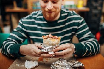 Start Buying From Companies You Invest In. Here's Why.: https://g.foolcdn.com/editorial/images/750527/22_12_19-a-person-eating-a-burrito-in-a-restaurant-_mf-dload.jpg