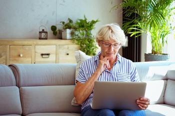 Will Signing Up for Medicare Impact Your Health Savings Account?: https://g.foolcdn.com/editorial/images/717629/senior-woman-holding-laptop-gettyimages-1278976690.jpg