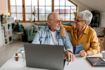 Retiring Well Ahead of Your Spouse? 3 Pitfalls to Be Wary Of: https://g.foolcdn.com/editorial/images/744815/senior-couple-laptop-gettyimages-1492831728.jpg