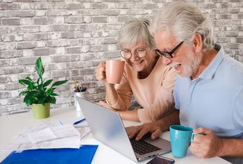 The New Magic Number for Retirement Is $1.5 Million. Investing in This ETF Can Help You Get There: https://g.foolcdn.com/editorial/images/774673/a-couple-sitting-and-using-a-laptop.jpg