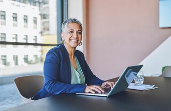 Here's Why Transitioning Into Retirement May Be Your Best Bet: https://g.foolcdn.com/editorial/images/744691/senior-woman-laptop-smiling-gettyimages-1414393948.jpg